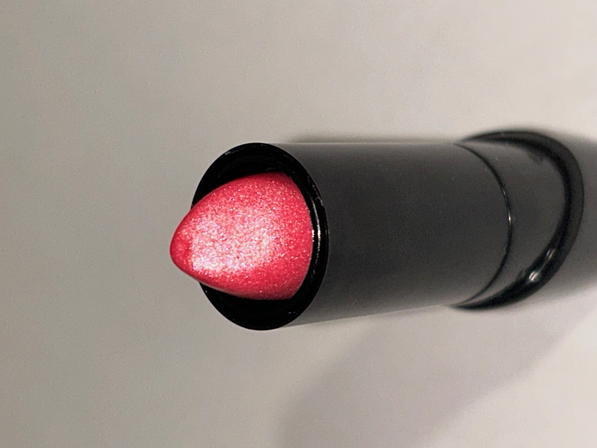 A close-up of the lipstick with heavy emphasis on the lipstick pigment. I noticed that the lipstick tends to glisten rather than shimmer and had a slight corally sheen to it as well